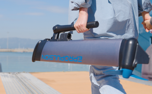 Image of engine being carried by folded tiller